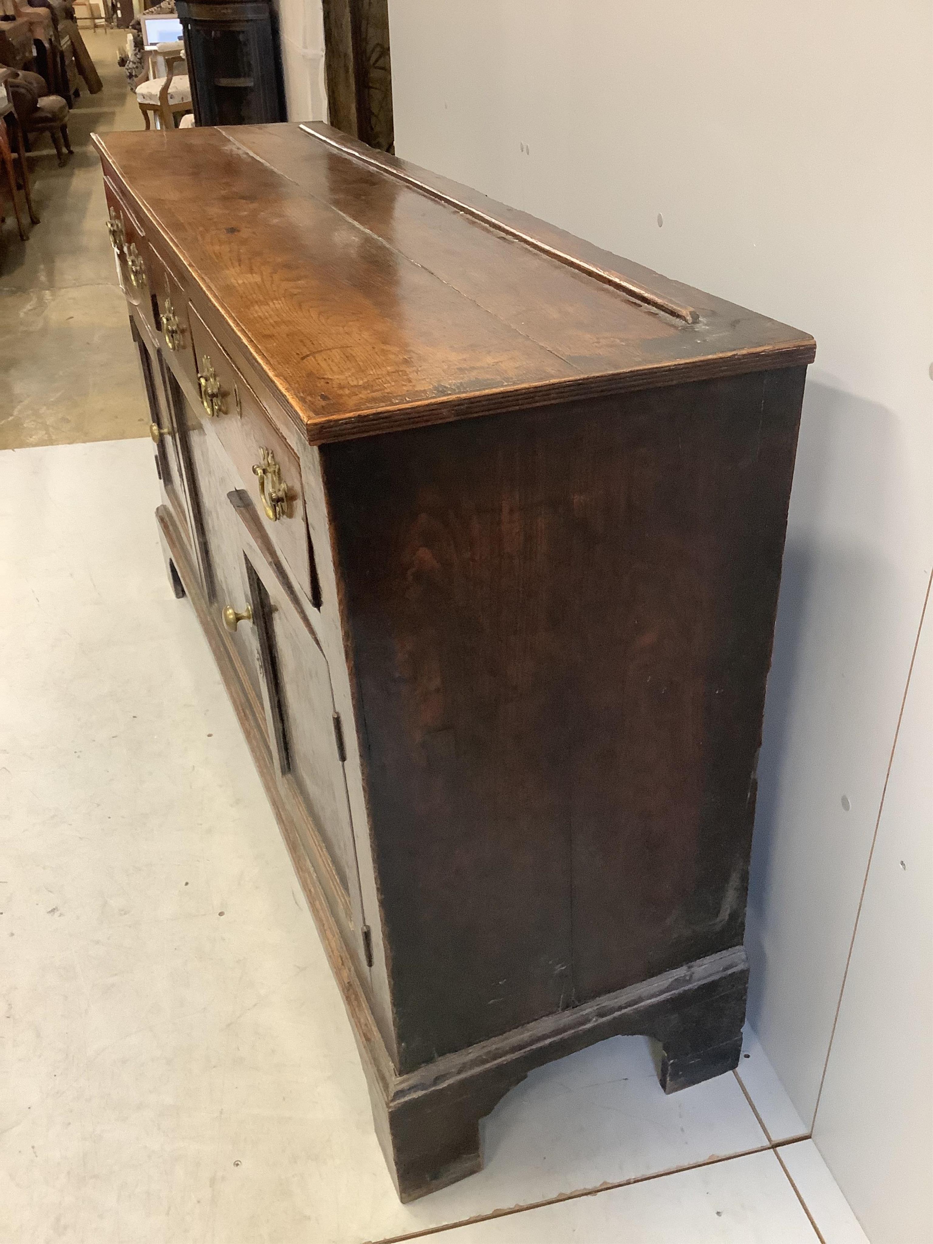 An 18th century oak low dresser, width 154cm, depth 42cm, height 90cm. Condition - fair